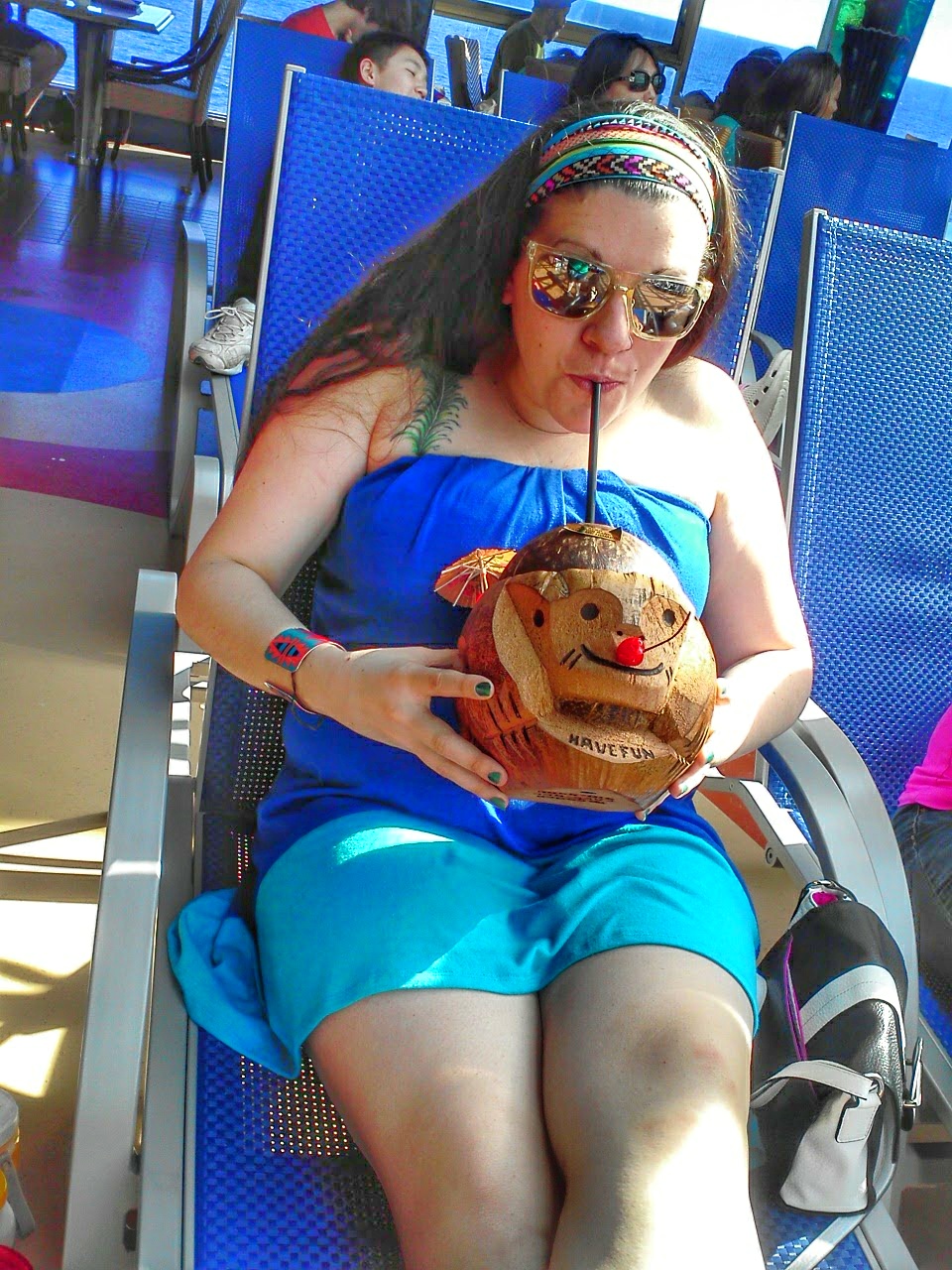 drinking from coconut on cruise ship lido deck